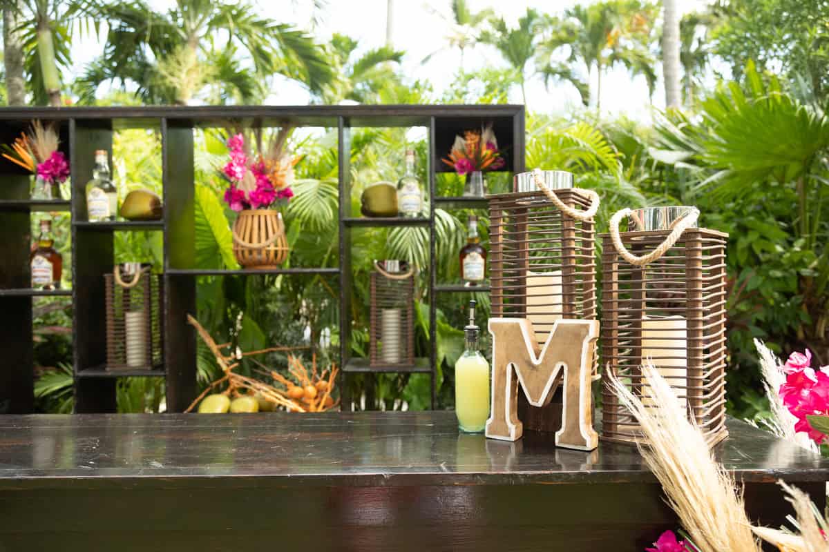 a wooden table with candles and bottles on it.  Wedding Decor, Sandals  Resort